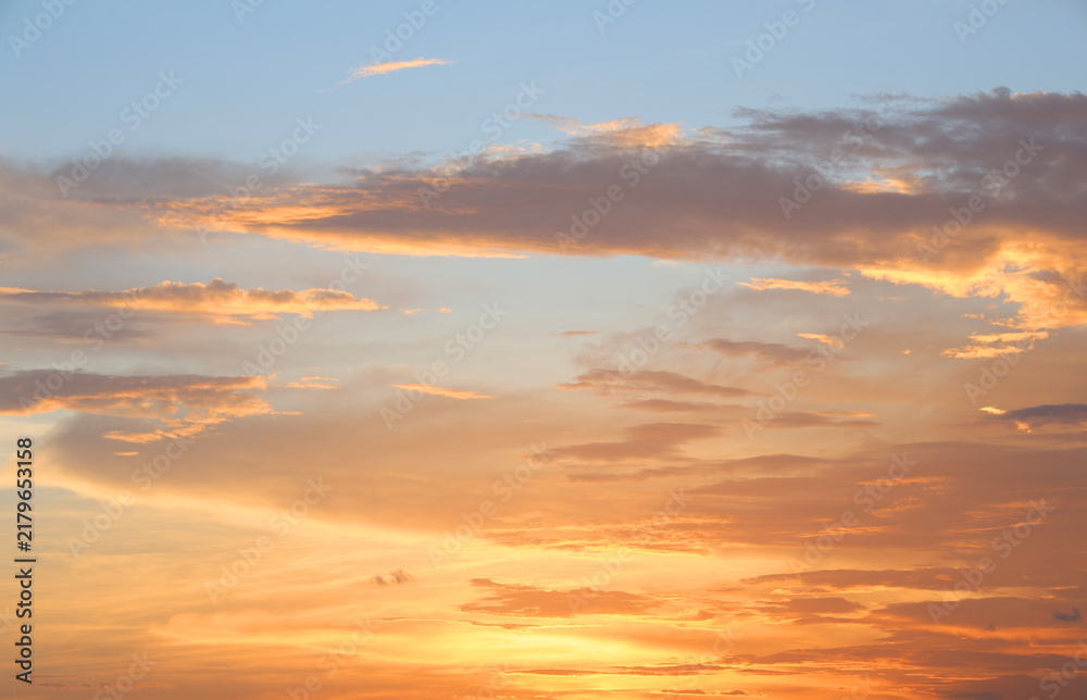 Fototapeta premium Orange and blue sunset sky with clouds