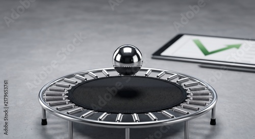 Metal sphere bouncing on a mini trampoline with a growth chart on a digital tablet screen.