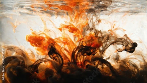 Vibrant Orange and Black Ink Swirling in Water for Artistic Effect