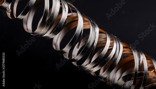 macro shot of metallic shavings curling abstractly against a black background