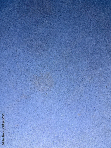 Blue textured surface with subtle gradient and granular detail