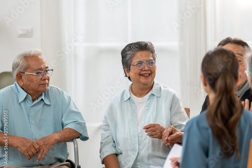 Fotografie Cheerful group senior Asian men and women sitting in circle, laughing and sharin