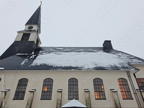 Low-angle exterior view of Rovaniemi Church in Finland after a winter snowfall.