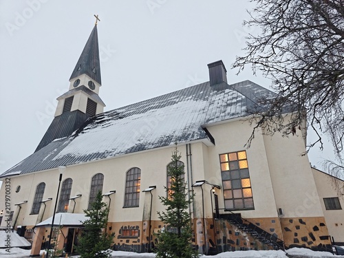 Exterior view of Rovaniemi Church in Finland covered in winter snow