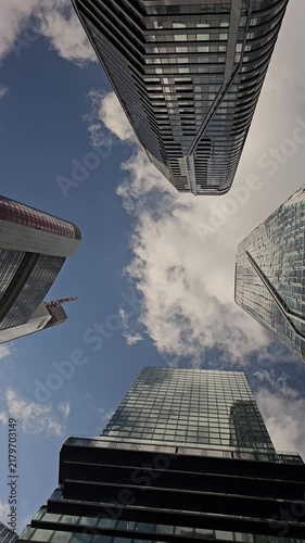 Upward View of Modern Skyscrapers Framing Blue Sky