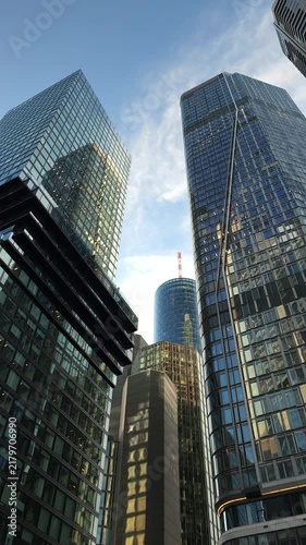 Looking Up Between Modern Skyscrapers Under Blue Sky