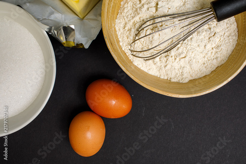 Canvastavla Baking ingredients including brown eggs, flour, sugar, and butter arranged with