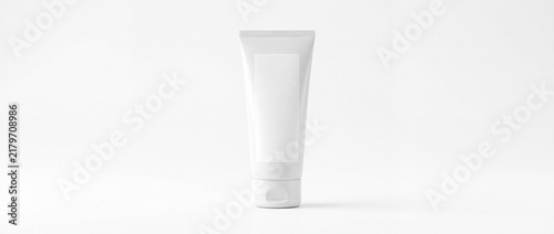 Blank white tube standing upright on plain white background