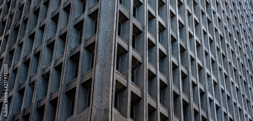 Muted Shades of Gray and Silver on a Monolithic Building.