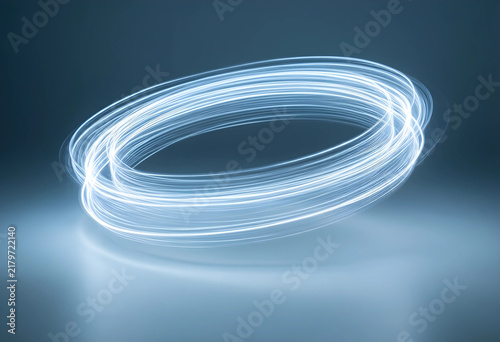 Innovation and technology concept  abstract light trails forming a glowing ring with motion blur and futuristic energy flow on a dark blue background