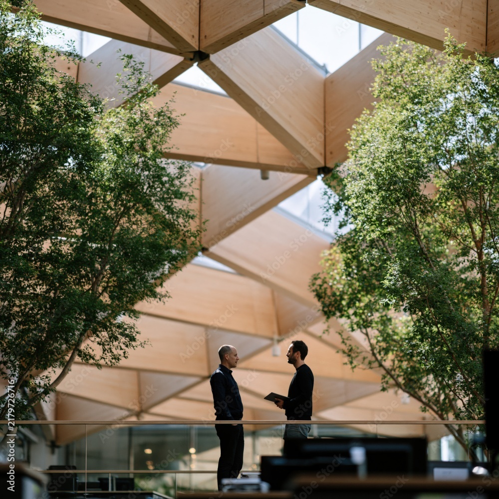 Obraz premium Contemporary workplace atrium with timber lattice roof and green indoor planting for business discussion background and corporate interior design
