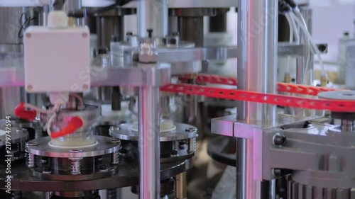 Close up view: automated high speed paper cup making machine is working for manufacturing coffee cups at factory, exhibition. Industrial, production, equipment and technology concept
