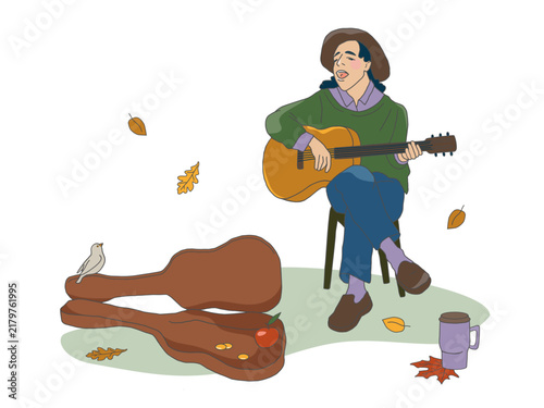 Young musician playing acoustic guitar and singing outdoors in autumn park, casual street performance scene with guitar case and falling leaves.