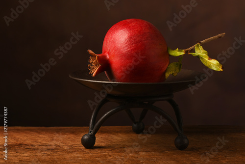 A single Pomegranate on a pedestal
