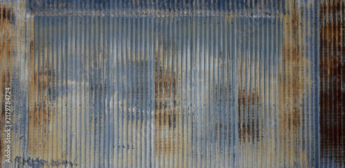 Fotografie Blue tinted corrugated galvanized metal surface with rust showing a blue upper b