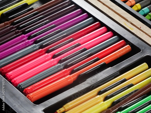 Colorful marker pens arranged in rows
