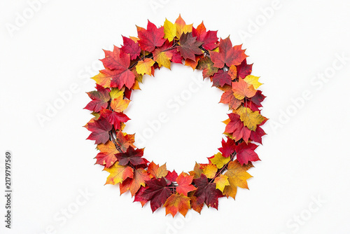 Autumn wreath made of colorful maple leaves isolated on white background