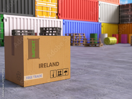 Cardboard Import Box with Ireland Text in Front of Stacked Shipping Containers