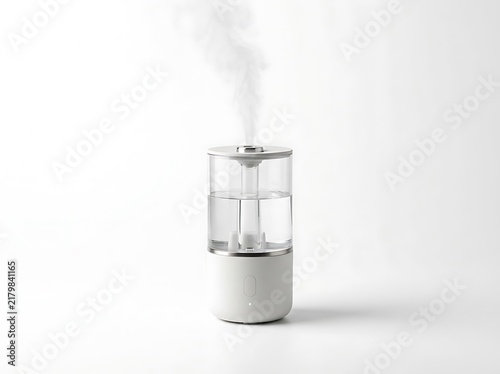Modern humidifier releasing mist vapor isolated on white background