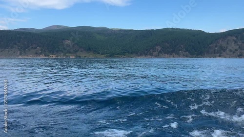 Cruising on a ferry boat over deep blue lake water