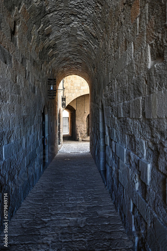 Stone arched medieval corridor with lanterns - Old town, Rhodes Island, Greece