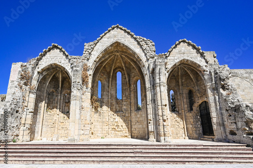 Gothic stone ruins and arches under deep blue sky - The ruins of Church of the Virgin Mary of the Burgh at old town Rhodos, Greece.