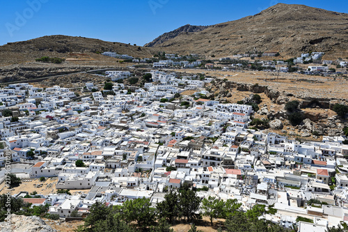 Panoramic aerial view of whitewashed Mediterranean hillside town from Lindos Castle, Rhodes Island, Greece