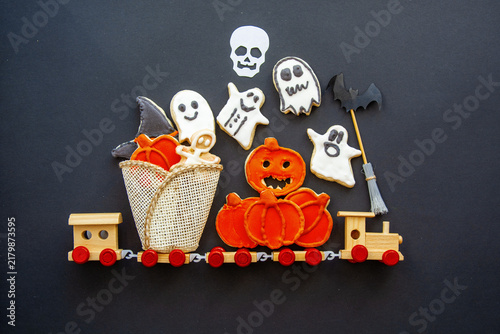 Halloween gingerbread cookies, Top view of spooky Halloween cookies in a bucket with autumn leaves
