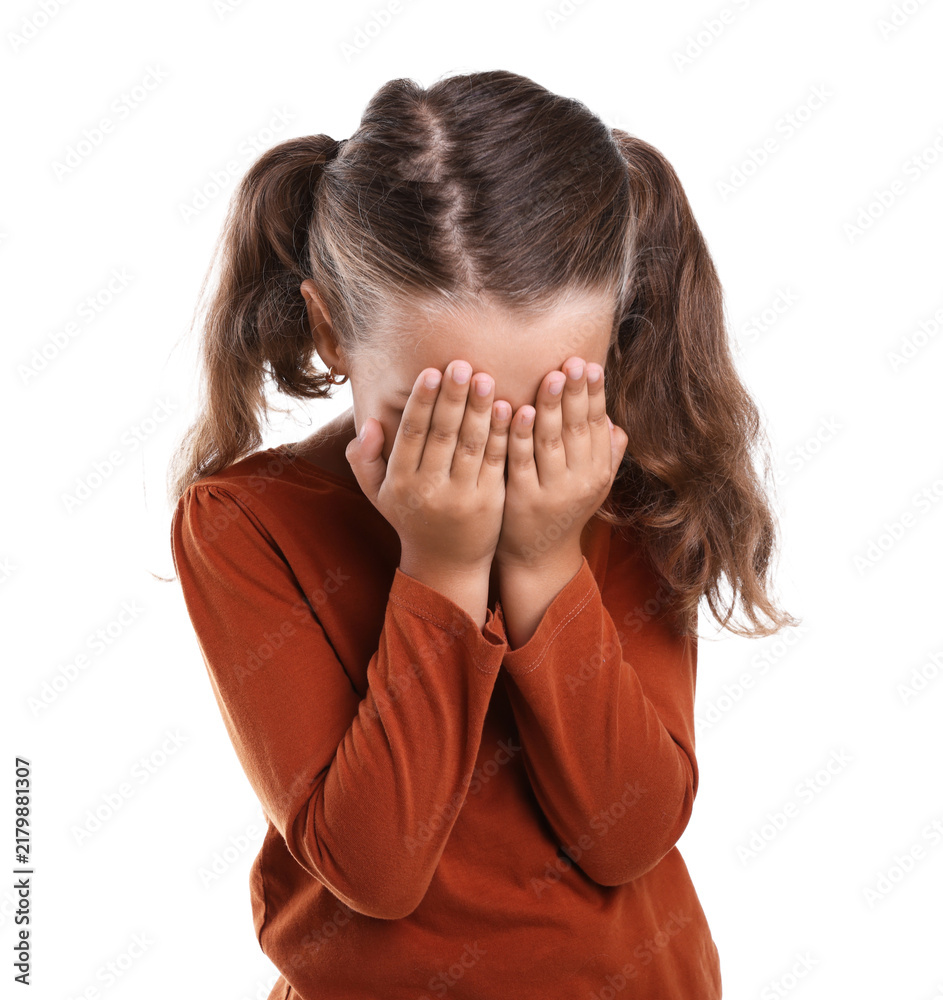 Fototapeta premium Stress. Scared little girl hiding her face on white background