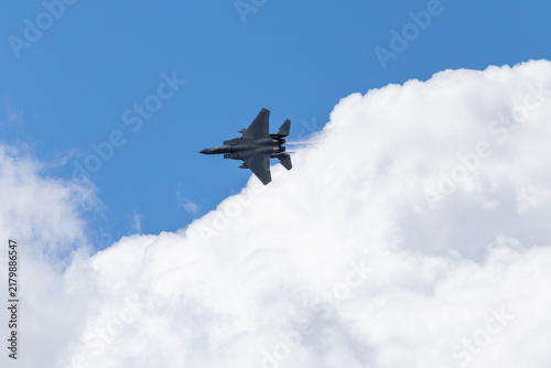 Obraz na płótnie F-15 Eagle  in a tight turn, with afterburners on, against clouds