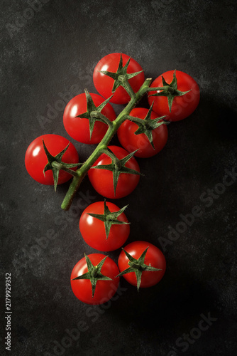 Cherry tomatoes top view on black background