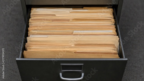 Open filing drawer full of unlabelled manila folders