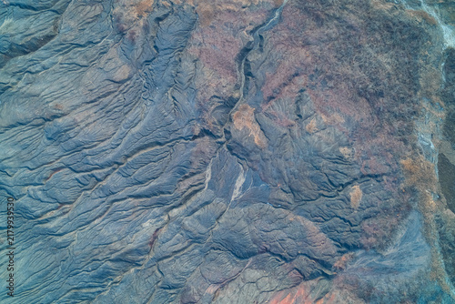Obraz na plátně Grey slag heap surface with radial erosion ridges and deep gullies, top view aer