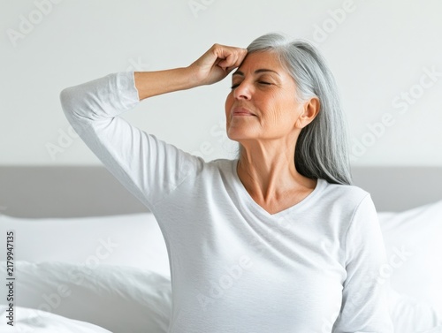 Calm and Relaxed Mature Woman Practicing Mindfulness in a Cozy Bedroom Atmosphere