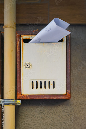 Fotografie Old Metal Mailbox with Paper Envelope