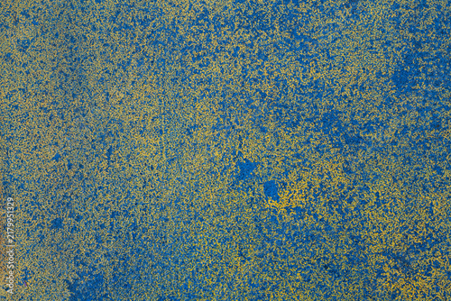 Blue and yellow painted metal texture background with heavily worn speckled paint and mottled pattern