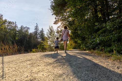 Mother And Son Walking Hand In Hand On Vedder Rotary Trail In Chilliwack BC Canada
