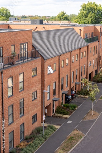 Photography Modern Urban Residential Building with Brick Facade and Rooftop Terraces on a Cl