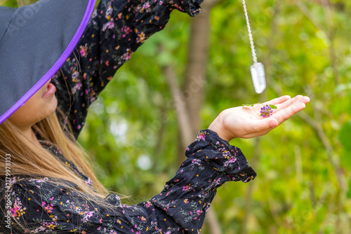 Картината върху платно little sorceress performing magic ritual with crystal pendulum in magic forest,