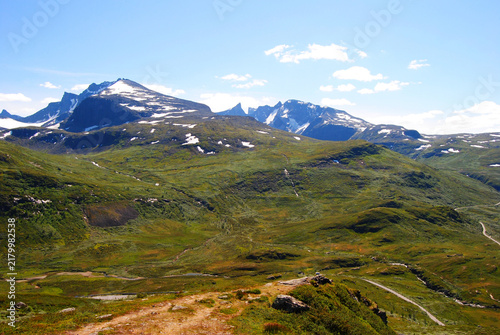 Vast green alpine landscape with snow-capped peaks in Sognefjellet, Norway
