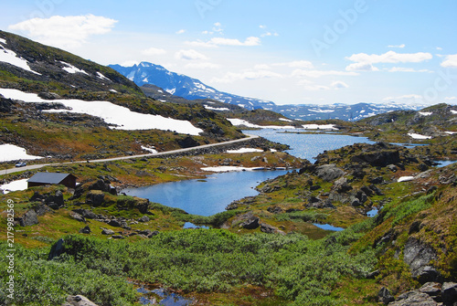 Alpine lakes and snowy mountain landscape in Sognefjellet, Norway