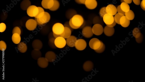 Golden yellow bokeh lights on black background