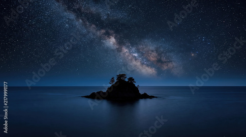 Milky Way Galaxy over Dark Mountain Lake with Island Silhouette at Night, Ai Generated