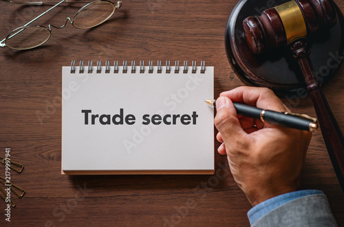 Trade secret safeguarding in business: notebook with legal symbols representing confidentiality and IP protection — ideal for compliance and governance articles