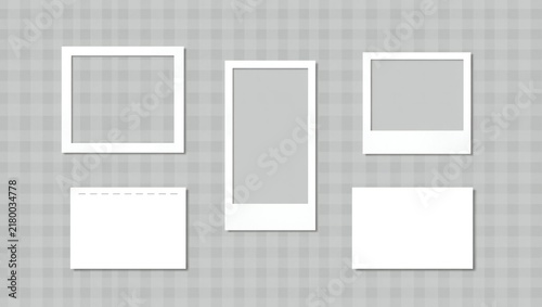 Set of blank photo frames and paper cards for pictures on a gray background