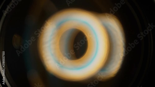 Abstract circular light patterns moving against a dark background on transparent background