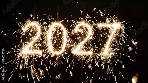 Sparkling numbers 2027 formed by glowing light trails against dark on transparent background