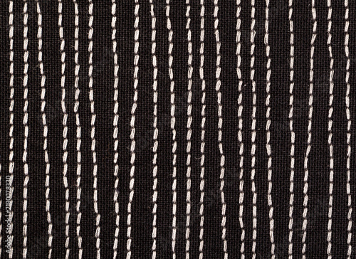 Black fabrick with white stitches background texture