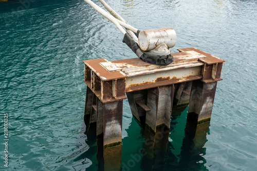 Принти на полотні Metal mooring block in the water with ropes securing boats and vessels, showing