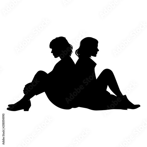 silhouette of two woman sitting back to back on the floor